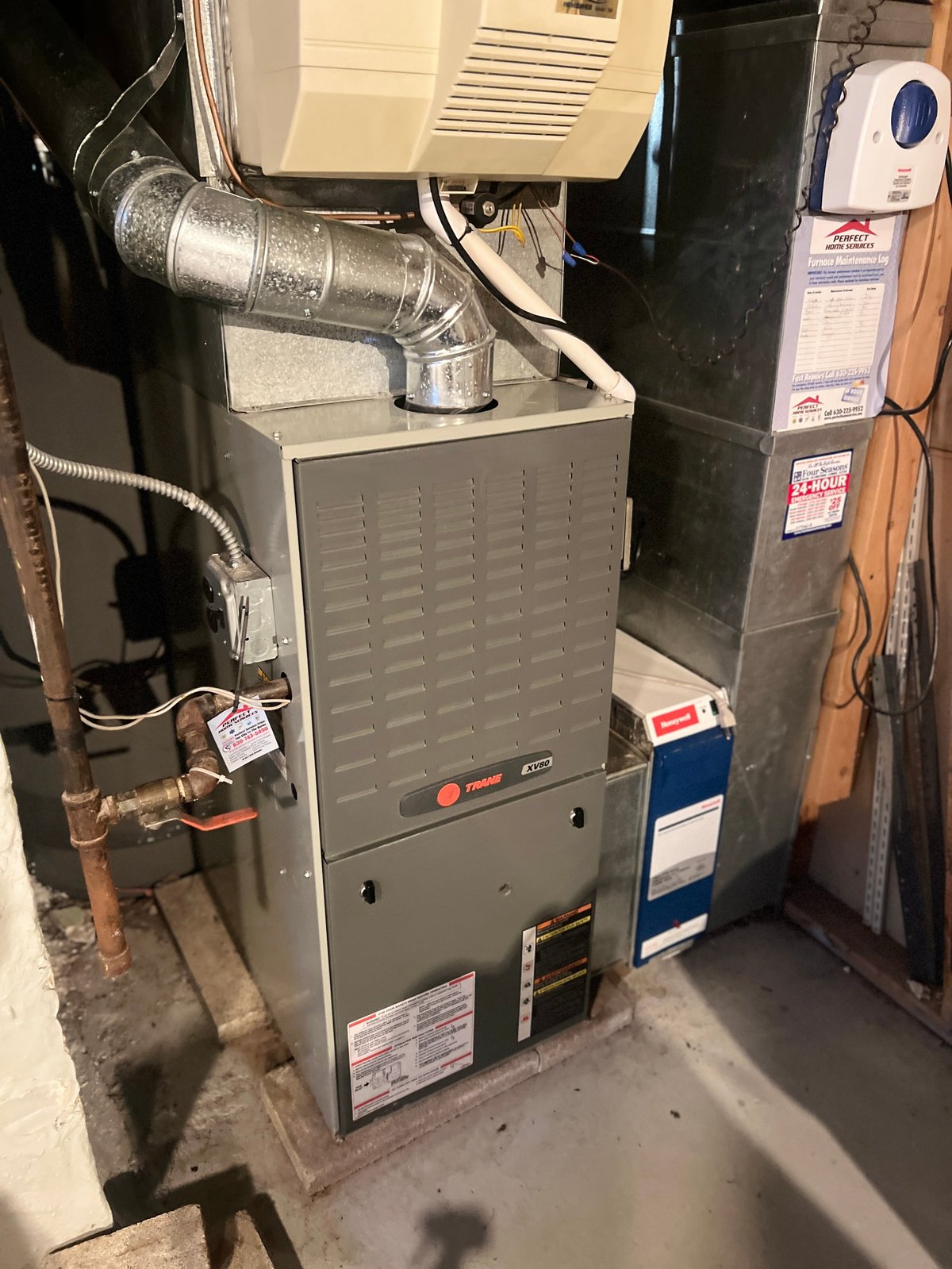 HVAC furnace system with metal ductwork and pipes in basement or utility room
